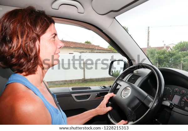 forties\
middle aged woman driver in car van in summer\
day