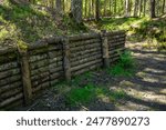 A fortification made of logs in the forest.Trench, trench, dugout.