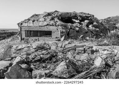 Fortifications of the Second World War in the Baltic. The bunker (pillbox) on granite island is made of wild stones, military point hit by shell, ceiling collapsed. Object suitable for military tour  - Shutterstock ID 2264297245