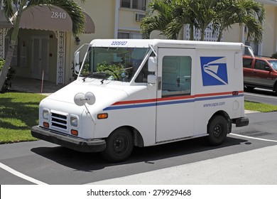 FORT-LAUDERDALE, FL, USA - JUNE 5, 2014: One Deliver Mail Parked In Front Of A Residential Condominium On A Sunny Day. USPS Mail Delivery Truck Parked On A Neighborhood Street. 