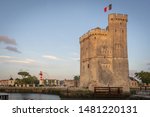 The Fortress La Rochelle  France. Towers of La Rochelle. Saint Nicolas Tower with French Flag. Town and fortress in western France and seaport on the Bay of Biscay in Atlantic. Medieval fortifications