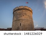 The Fortress La Rochelle,  France. Towers of La Rochelle, Tower of the Chaine (tour de la Chaine). French Flag. Town and fortress in western France and seaport on the Bay of Biscay in Atlantic Ocean. 