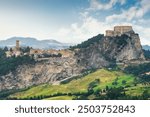 The Fortress of San Leo or Rocca di San Leo on the right and the village on the left, province of Rimini, Emilia Romagna region, Italy