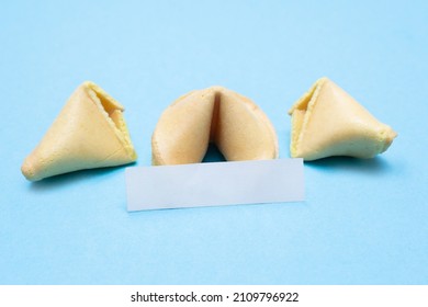 Fortune Cookie On A Blue Background And Place For Text. Mockup. Blank Paper For Writing A Fortune.