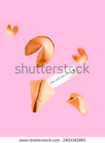 Fortune cookies with text you will be loved fly on pink background. Minimal art Valentine's day card.