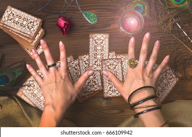 Fortune teller female hands and tarot cards on wooden table. Fortune teller. - Shutterstock ID 666109942