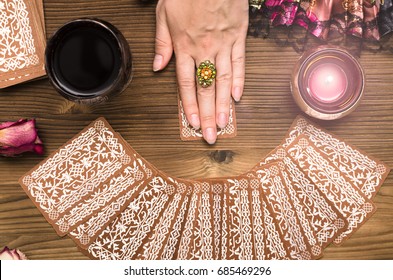 Fortune teller female hands and tarot cards on wooden table. Divination concept.  - Shutterstock ID 685469296