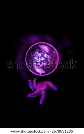 Fortune teller hand casting a spell over a crystal ball for divination, foresight, Halloween ritual in the darkness of the night