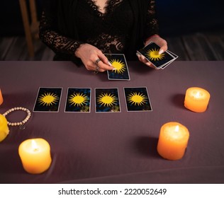 Fortune teller hands and tarot cards on wooden table. Divination - Shutterstock ID 2220052649