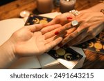 Fortune teller reading lines on woman