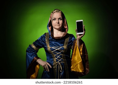 A Fortune Teller Shows The Screen Of Her Cell Phone To The Camera On A Dark Green Background