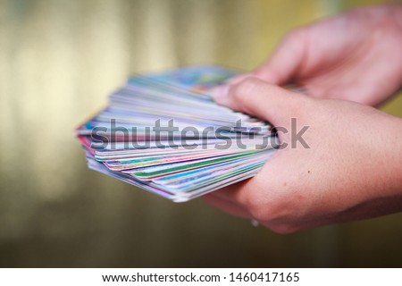 fortune-tellers' hands hold a deck of tarot cards on a gold background. 63 full oracle deck.