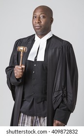 Forty Something, Bald, African American Wearing A Canadian Lawyer Toga Holding A Gavel