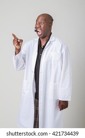 Forty Year Old Black Man, Wearing A Lab Coat And A Telephone Headset, Pointing And Screaming At Something