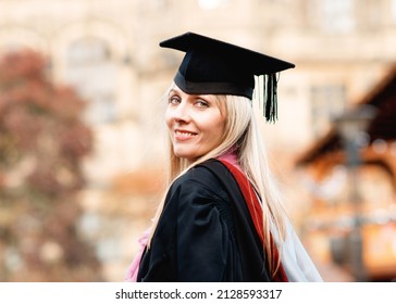 Forty - Year - Old Happy Woman In Graduation Gown Walking Around City Center.  Study At Any Age