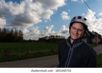 Forty Year Old Man With A Helmet On His Bicycle At The Flemish Countryside