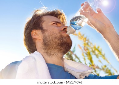 Forty Years Old Caucasian Active Man Drinking Water And Having A Rest After Workout During Sunny Summer Day