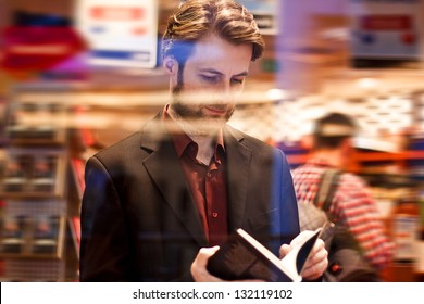 Forty Years Old Elegant Man Standing Inside Bookstore Reading A Book