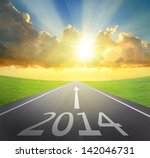 Forward to 2014 new year concept , asphalt road with arrow , date and beautiful sunset and sunshine