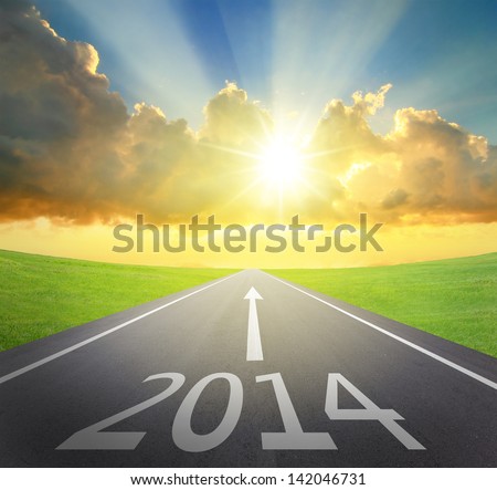 Forward to 2014 new year concept , asphalt road with arrow , date and beautiful sunset and sunshine