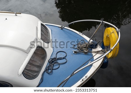 Forward area of a small fishing boat. Seen moored on an inland waterway in the UK.