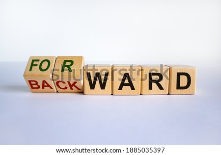 Forward or backward symbol. Turned cubes and changed the word 'backward' to 'forward' on wooden cubes. Beautiful white background, copy space. Business and forward or backward concept.