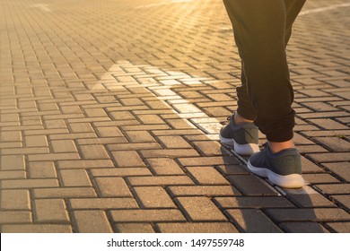 Forward Moving. Feet On Road Arrow In The Rays Of Setting Sun