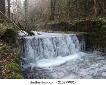 Forzen waterfall in forest, winter
