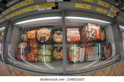 Fossano, Italy - April 15, 2022: Refrigerated Counter With Packs Of Frozen Precooked Pizzas For Sale In INS Supermarket Discount Store, PAM Group. Fish Eye Vision In Top View