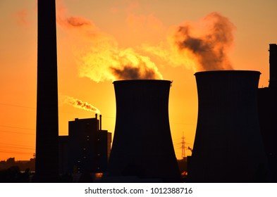 Fossil Fuel Energy Plant Emitting Carbon Dioxide - Backlit Against Sunset