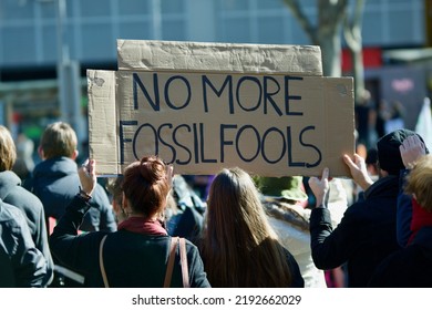 Fossil Fuels Sign At Climate Change Protest In Melbourne Australia. People Holding Sign Saying No More Fossil Fools. Promoting Clean Green Energy.