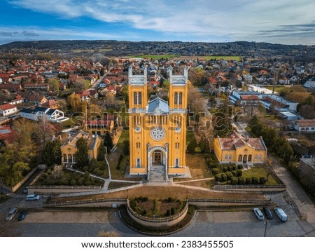 Fot, Hungary - Aerial view of the Roman Catholic Church of the Immaculate Conception (Szeplotlen Fogantatas templom) in the town of Fot on a sunny spring day with blue sky and clouds