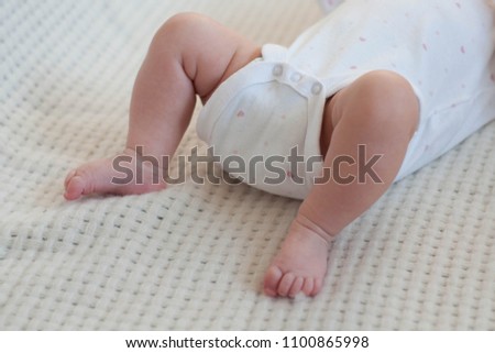 Foto of little baby's tiny feet with cute toes. Infant body parts.