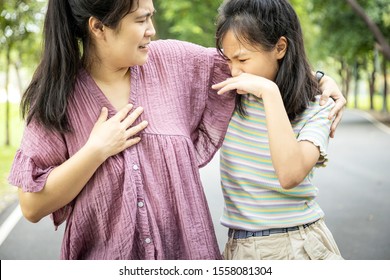 Foul-smelling woman was hug her daughter while her child girl closing nose and can smell the armpit smelly or the body odor foul from her mother,feel stinks,asian female smell ,sweat from hot weather