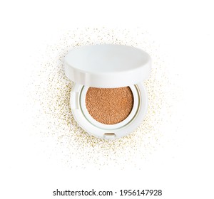 Foundation cushion powder with puff. Cosmetic face powder in the golden glitter circle isolated on white background