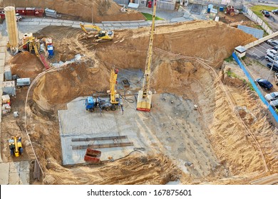 Foundation Ditch With Construction Machinery At Construction Site, High Angle View