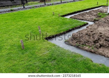 Foundation footings poured in a ditch in the yard, building a terrace in the backyard. Stock foto © 