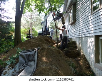 Foundation Lifting. Repair And Lifting Of A Foundation That Has Settled.  Brackets, Equipment, Holes, Dirt