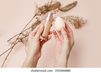 Foundation With Make Up Beuty Blender In Female Hands On A Trendy Beige Brown Earth Tones Background. BB Cream For Professional Make-up. Cosmetic Female Accessory, Liquid Fluid, Stylish