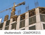 The foundation on reinforced concrete piles and the frame during the construction of a multi-storey building. Reinforcement of reinforced concrete columns. Construction of high-rise buildings.