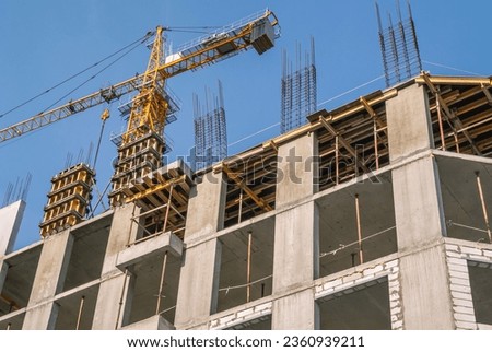 The foundation on reinforced concrete piles and the frame during the construction of a multi-storey building. Reinforcement of reinforced concrete columns. Construction of high-rise buildings.