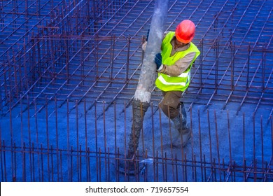 Foundation Pouring. Pouring Concrete. The Worker Pours Concrete Into The Foundation.