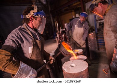 Foundry Worker Pouring Hot Metal Into Cast