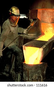 Foundry Worker Pouring Molten Metal Into Mould