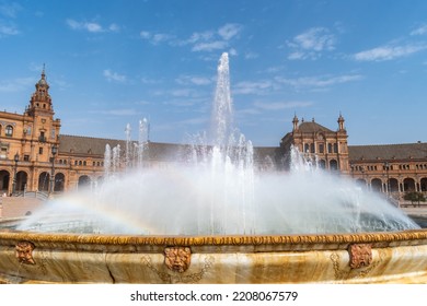 Fountain With Decorative Faces Spouting Water, Spray With Rainbow Effect In Plaza De España, Seville SPAIN