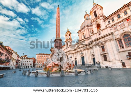 Fountain of the Four Rivers with an Egyptian obelisk and Sant Agnese Church on the famous Piazza Navona Square in the morning, Rome, Italy.