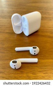 Fountain Hills, Arizona USA - February 22, 2021: A Pair Of Apple AirPods Are Inspected On A Table For Cleaning. Ear Wax Can Build Up On The Head Phones And Needs To Be Removed For Maintenance.