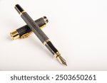 Fountain pen, beautiful fountain pen positioned on white background, selective focus.