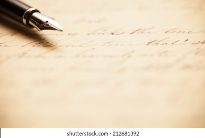 Fountain pen on an antique handwritten letter