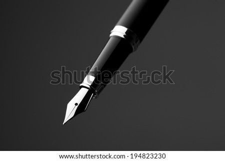Fountain pen on black background